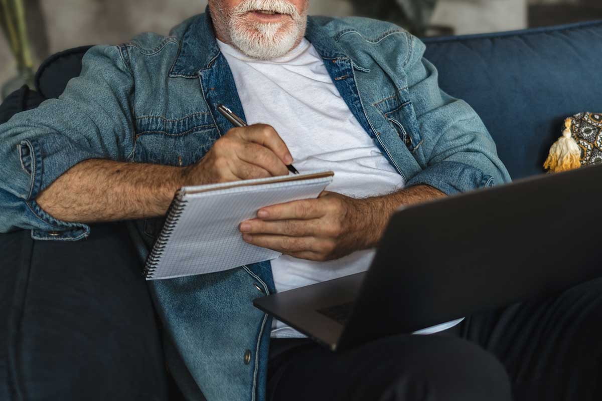 man writing notes